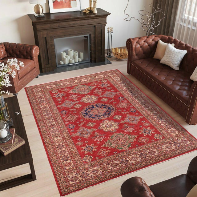Enhance your home with this exquisite hand-knotted Super Kazak rug, crafted from fine hand-spun wool and dyed with all-...