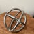 This vintage midcentury sphere sculpture is a one-of-a-kind piece made of solid metal in a stunning silver color. The...
