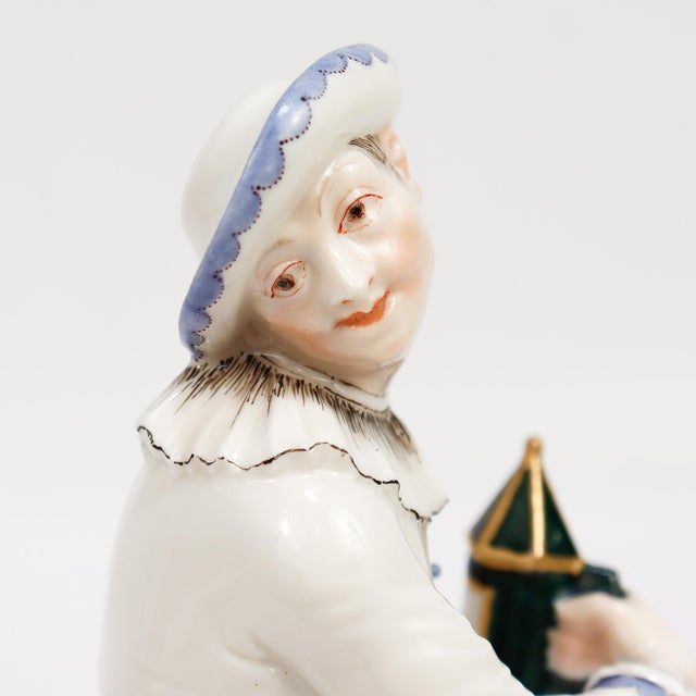 A fine painted and gilt porcelain figure of the commedia dell'arte character, Pierrot. By Nymphenburg. Pierrot depicted...