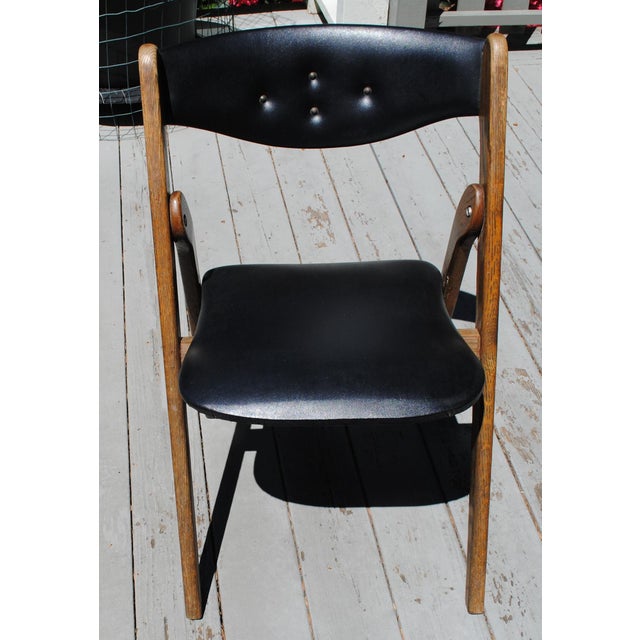 This mid-century folding chair is a great chair to have available when you need one more seat. It is also a great looking...