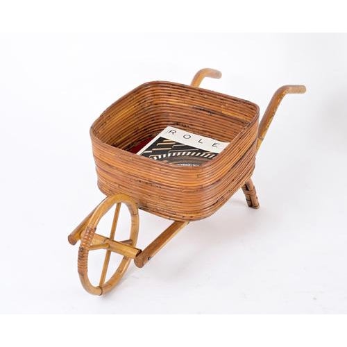 Delightful French Riviera decorative wheelbarrow fully made in curved rattan and knotted wicker that can be used as...