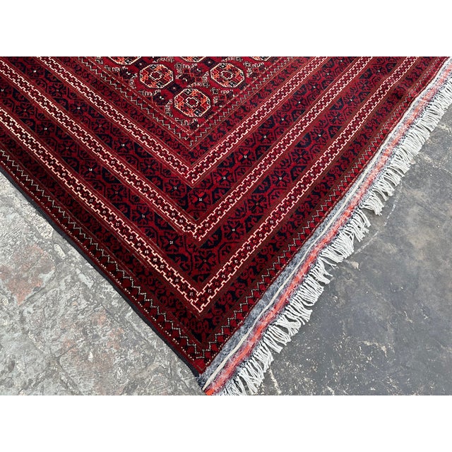 This hand-knotted Afghan rug uses natural colors and handspun wool. This lovely rug will enhance your home's style. This...