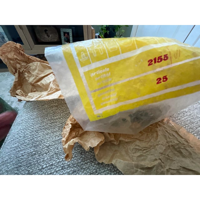 Elegant vintage chandelier, brought back from Italy decades ago, featuring a solid brass frame with ornate scrollwork,...