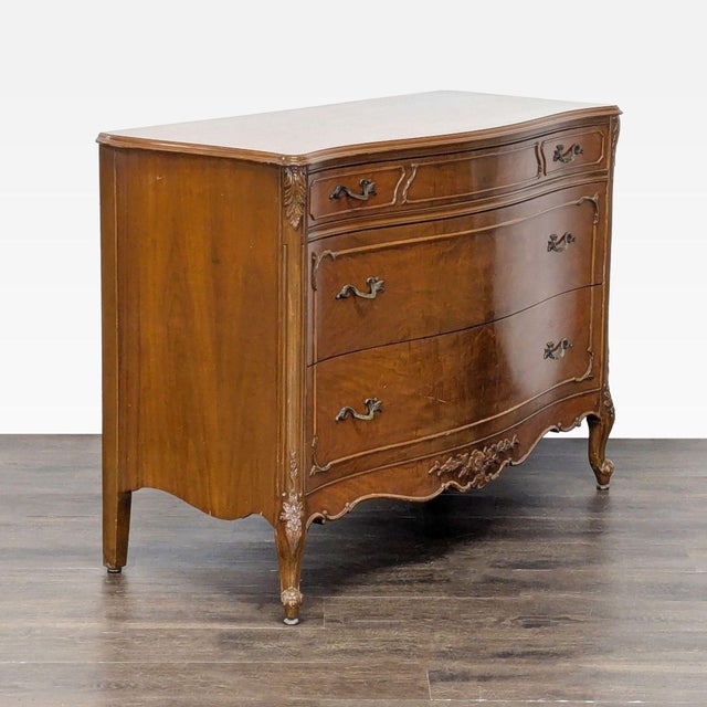 This John Stuart Inc. dresser offers timeless style with its curved front, wood construction, and elegant carved details....
