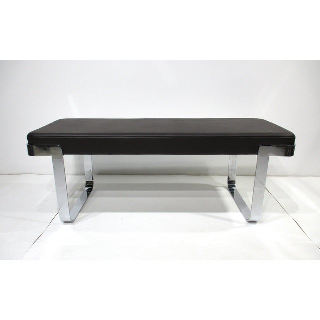 A very well crafted and heavy sculptural chrome banded bench upholstered in a luxurious dark chocolate leather. Designed...