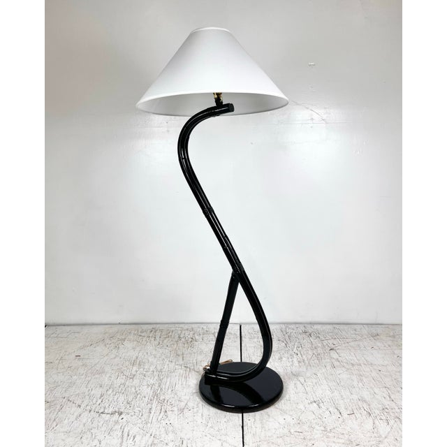 Mid century S shaped bent rattan floor lamp. Curved rattan on round wood base. Newly refinished in a glossy espresso...