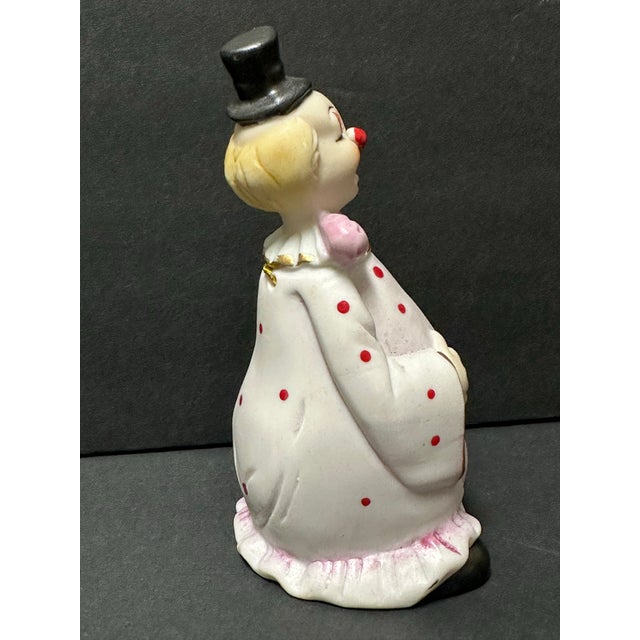 Vintage porcelain clown bell. Pink with red polka dots. Measures 2” x 2” x 5”.