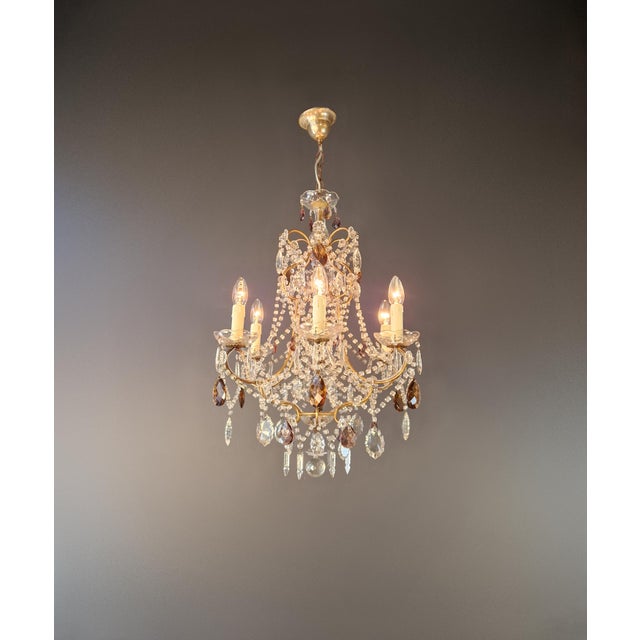 This decorative crystal chandelier captivates with its elegant, open structure, inspired by the Italian Rococo Revival...