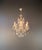 This decorative crystal chandelier captivates with its elegant, open structure, inspired by the Italian Rococo Revival...