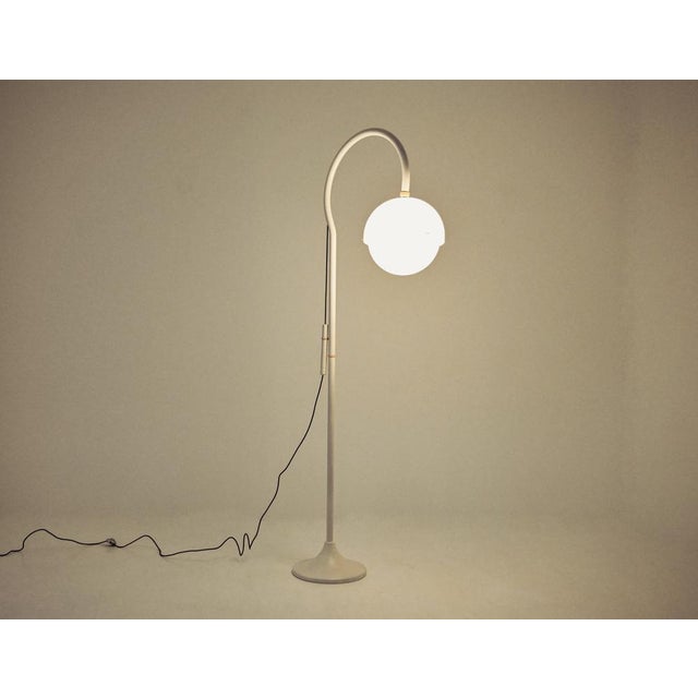 Metal and plastic floor lamp designed by Luigi Bandini Buti, model 4055. Wear due to time and age. This piece is...
