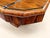An Art Deco style extendable dining table with an octagonal top featuring chamfered corners, covered in a book-matched...