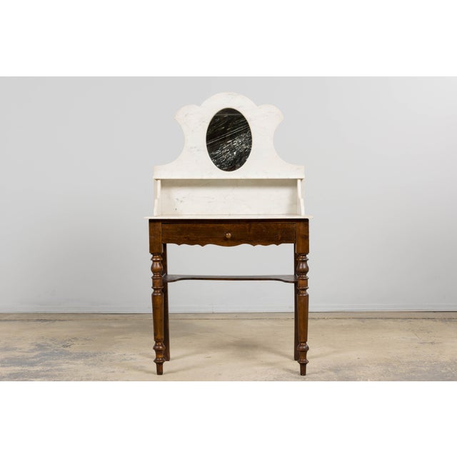An elegant late 19th century French Provincial wash table or vanity made in the Louis Philippe style, sourced in Provence,...
