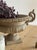 A cast iron French garden urn, the campana bowl edged in a band of leaf casting and flanked by a pair of scrolled handles,...