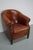 This cognac-colored leather club chair comes from the Netherlands. It is upholstered with cognac-colored leather and...