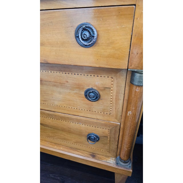 A French Directoire walnut commode, (chest of drawers) circa 1830. With graceful lines and fabulous hardware. It is 28"...