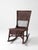 Early 20th century Victorian wicker rocking chair featuring a tall woven back, open lattice detailing, and a rich dark...
