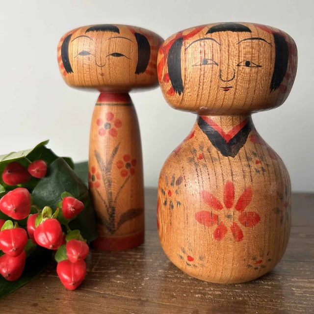 Unique set of two dento (traditional) kokeshi dolls. Both kokeshi are beautifully crafted with flatter heads than typical...
