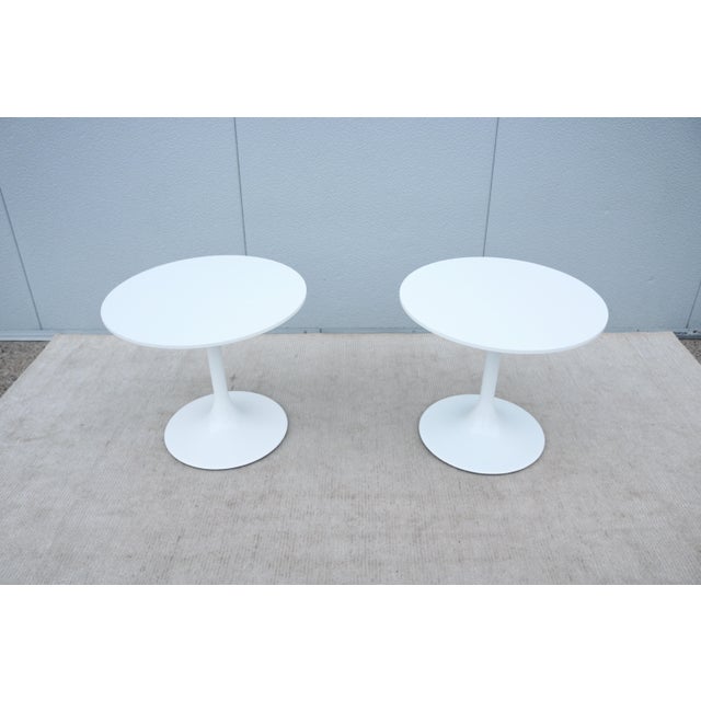Fabulous mid-century modern style pair of Nineteen20 side tables features a white Corian top with a white tulip pedestal...