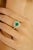 Radiating elegance and modern charm, this exquisite ring is crafted in luxurious 18k yellow gold. At its heart lies a...