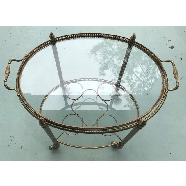 Mid Century Brass Oval Serving Cart with Removable Gallery Tray top and central 4 Bottle Rack. Glass is clear.