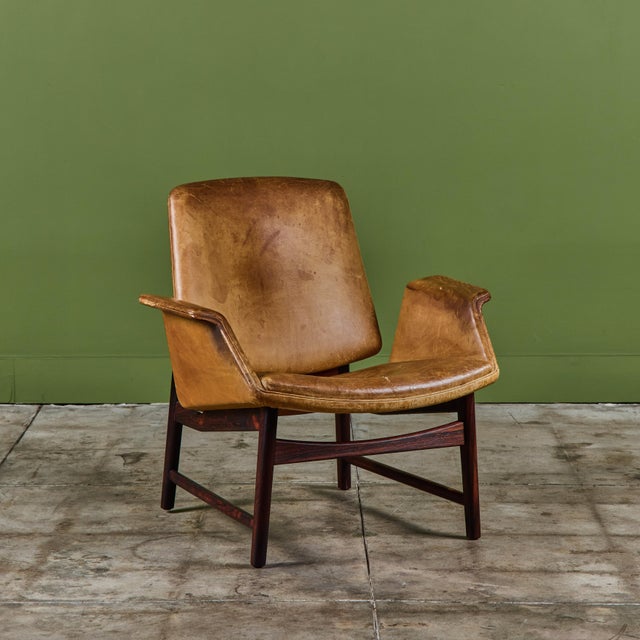 Designed in 1958 by Danish designer Illum Wikkelsø for Aarhus, this lounge chair features the original leather upholstery...