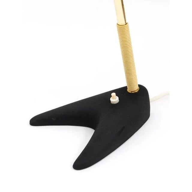 A beautiful modernist table lamp, manufactured by Kalmar Austria in the 1950s. Has a red adjustable cone-shaped lampshade...