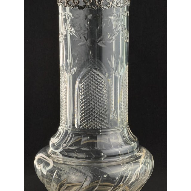 Elegant French Belle Époque vase combining fine hand-blown thin crystal and solid silver mounts. Marked with the French...