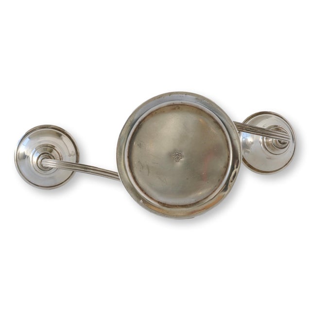 A matched pair of silverplate three-light candelabra from International Silver Co., circa 1930s–1940s. Each features...