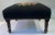 Beautiful black floral needlepoint footstool with a carved wooden base.