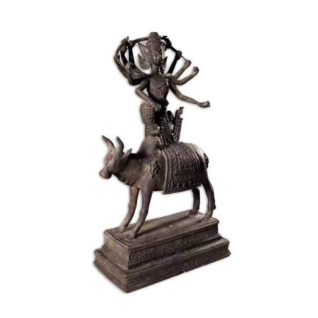 An antique Thai or Tibet gilt bronze statue depicting the Hindu God Lord Shiva on Nandi. The 10-armed deity iskneelingon...