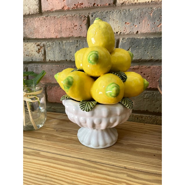 A bright yellow 11" tall ceramic Majolica Lemon Topiary sitting in a stunning pedestal bowl. Circa Mid 20th Century....