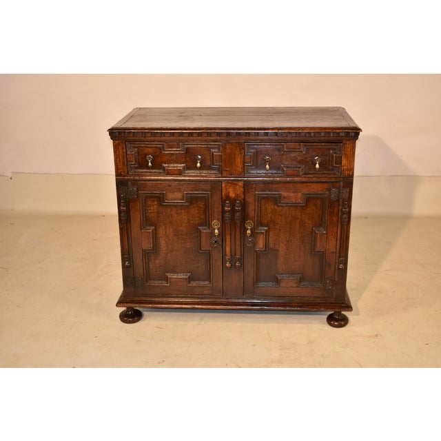 Period Jacobean oak buffet with exquisite geometric paneled detail. The top is nicely grained and has banded ends and a...
