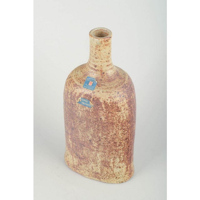 Blommenhus Keramik, Nyköping, Sweden. Bottle-shaped vase, 1960s. Hand-thrown stoneware vase with a tall neck and...