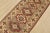 A tribal Caucasian Kazak runner hand-knotted with fine wool on a cotton foundation. This rug features geometric medallions...
