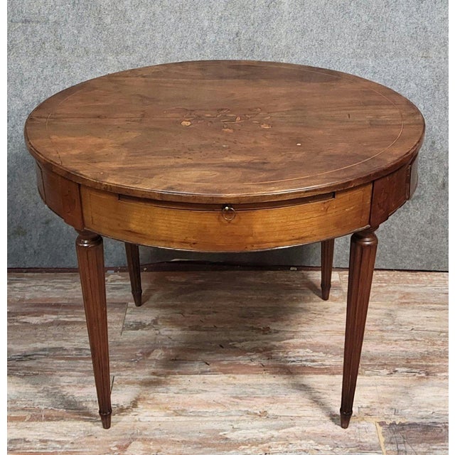Louis XVI period marquetry bouillotte table, circa 1790-1800, circular top opening in the apron with two drawers and two...
