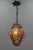 This beautiful Italian hanging lantern features clear amber smoke-colored Murano glass captivated within a metal frame....