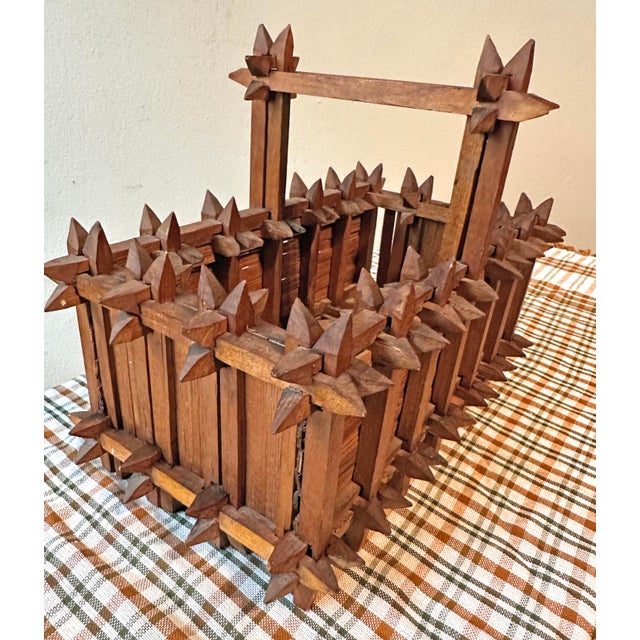 This object is a vintage piece of "Crown of Thorns" Tramp Art, handcrafted into the shape of a handled basket. It measures...