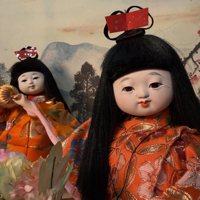 This complete Japanese seasonal display is presented in a wide glass case with a black lacquered wooden frame and an...