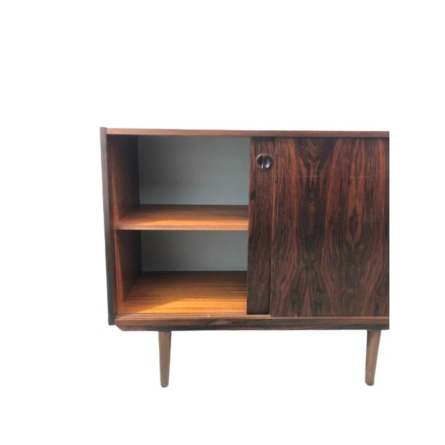 Mid Century Danish Modern Rosewood cabinet In style of Kai Kristiansen, manufactured in Denmark with adjustable shelf,...