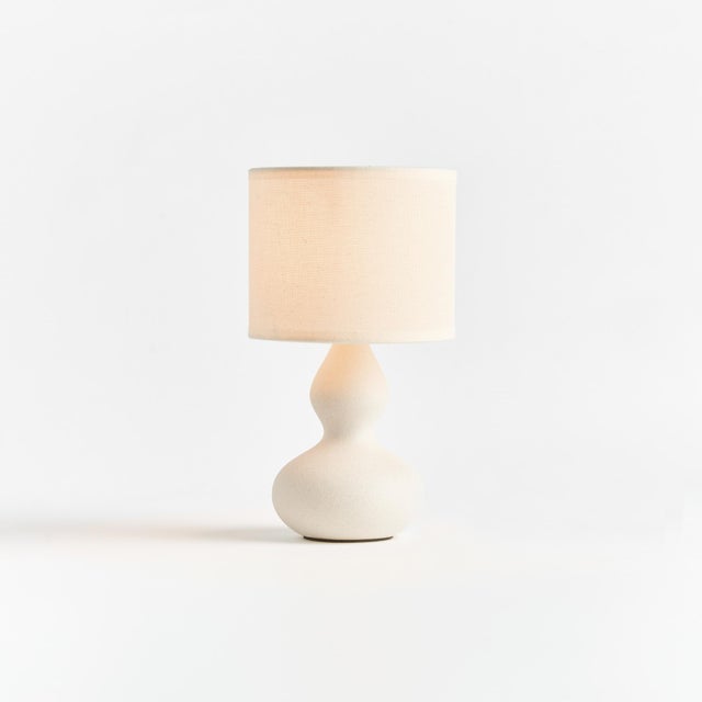 This sweet little ceramic lamp has a curvy silhouette. The wellscaled shade and matte finish complete the look. Perfect...