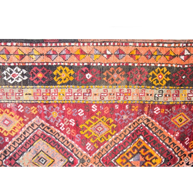 A bold and brilliant early 20th century Turkish Kars rug with several central diamond medallion running the length, and...