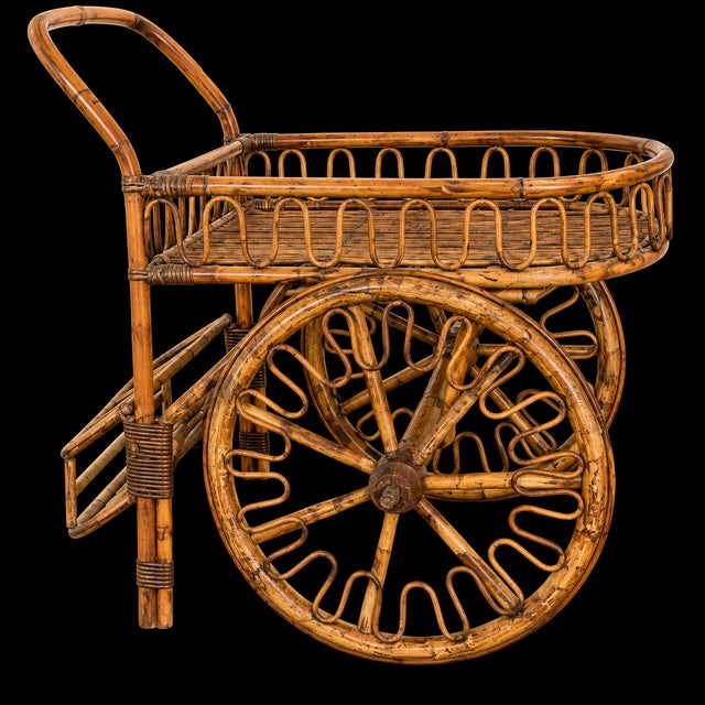 Striking vintage French Riviera–style rattan bar cart dating to circa 1950s, featuring an exceptionally sculptural design...