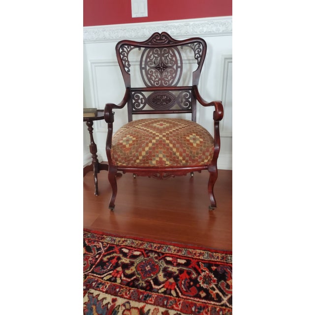 edwardian era mohagony parlor arm chair. 1890-1910. elegant open scrollwork. reaplostered with modern check fabric. Found...
