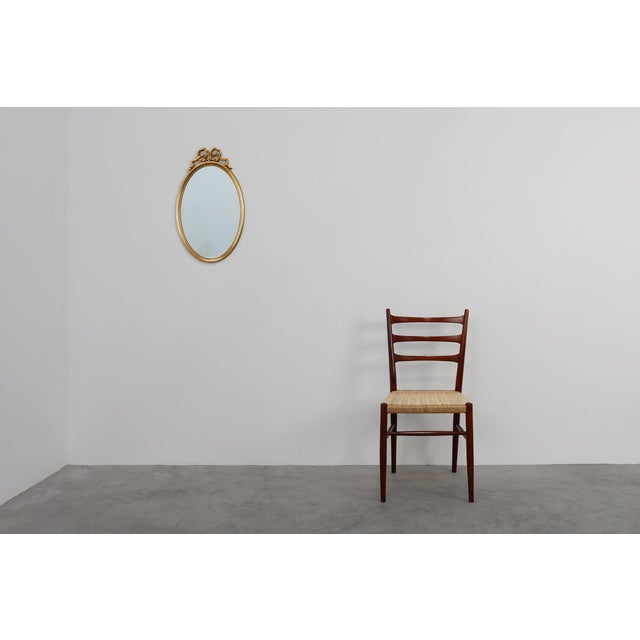 A refined french louis xvi style mirror from the 20th century, crafted in gilded wood and distinguished by its elegant...
