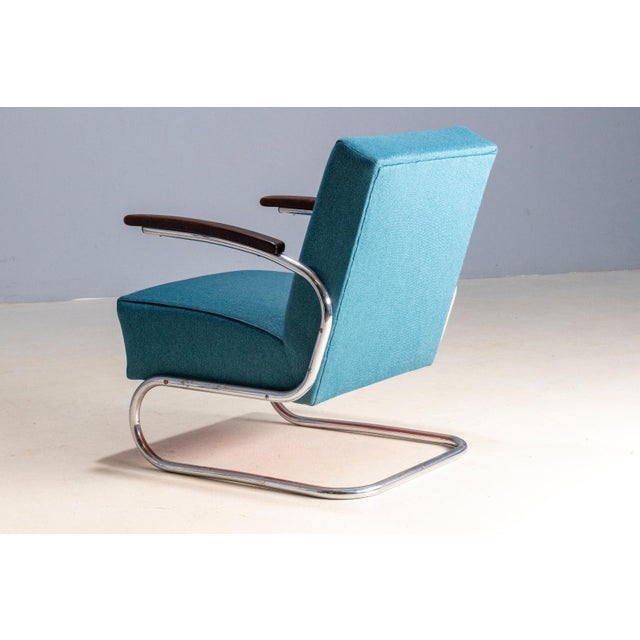 Pair of armchairs based on the S 411 model, produced in Europe during the mid-20th century. The design follows...