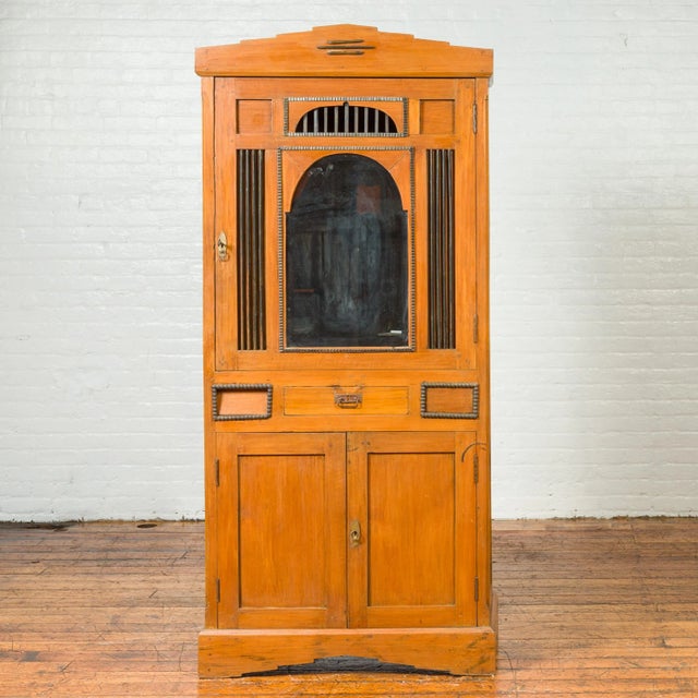 A vintage Dutch Colonial style cabinet from the mid-20th century, with doors, drawers and mirrored front. Crafted in...