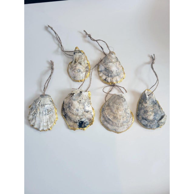 Set of six ornaments crafted from Connecticut Shores, Blue Point Oyster Shells with hand-applied gold rim. Each shell has...