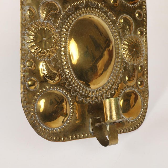 Made in Sweden A breath-taking mid-century duo of exquisite Swedish brass wall sconces, showcasing captivating hammered...
