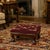 This early 20th century footstool is upholstered in a richly colored European floral needlepoint, worked on imported...