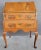 A 19th century Queen Anne secretary desk crafted in solid mahogany with flame mahogany detail. Fitted interior with pigeon...
